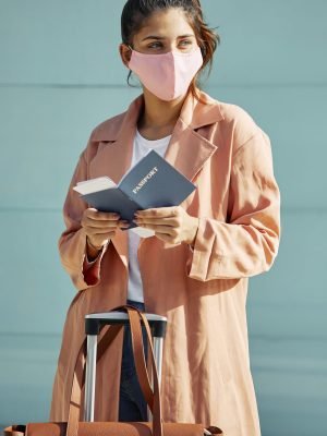 woman-with-medical-mask-airport-passport-pandemic