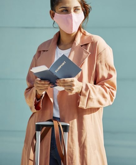 woman-with-medical-mask-airport-passport-pandemic